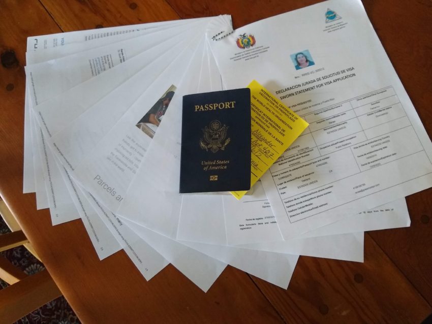 papers fanned out with passport and immunization card on top of them